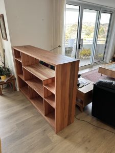Three-quarter view of an upcycled Blackbutt bookcase positioned near a window in Giralang ACT