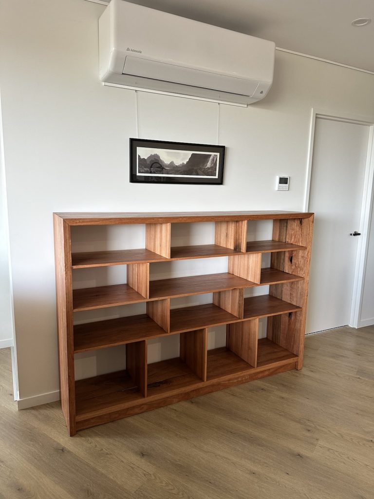 Blackbutt bookcase against the wall in the Giralang home