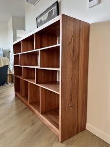 Angled side perspective of an upcycled Blackbutt bookcase highlighting end panel and shelves in Giralang ACT