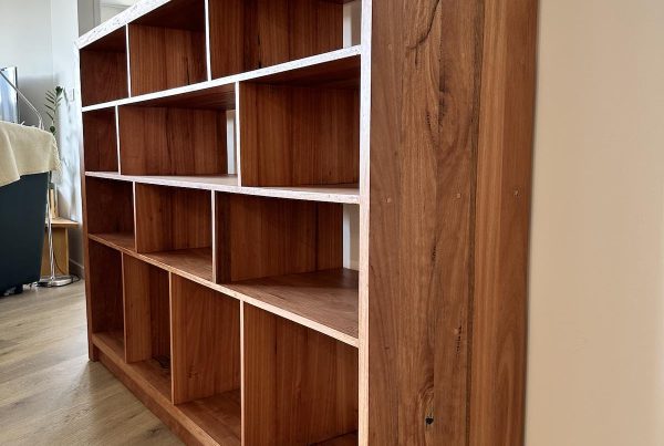 Angled side perspective of an upcycled Blackbutt bookcase highlighting end panel and shelves in Giralang ACT
