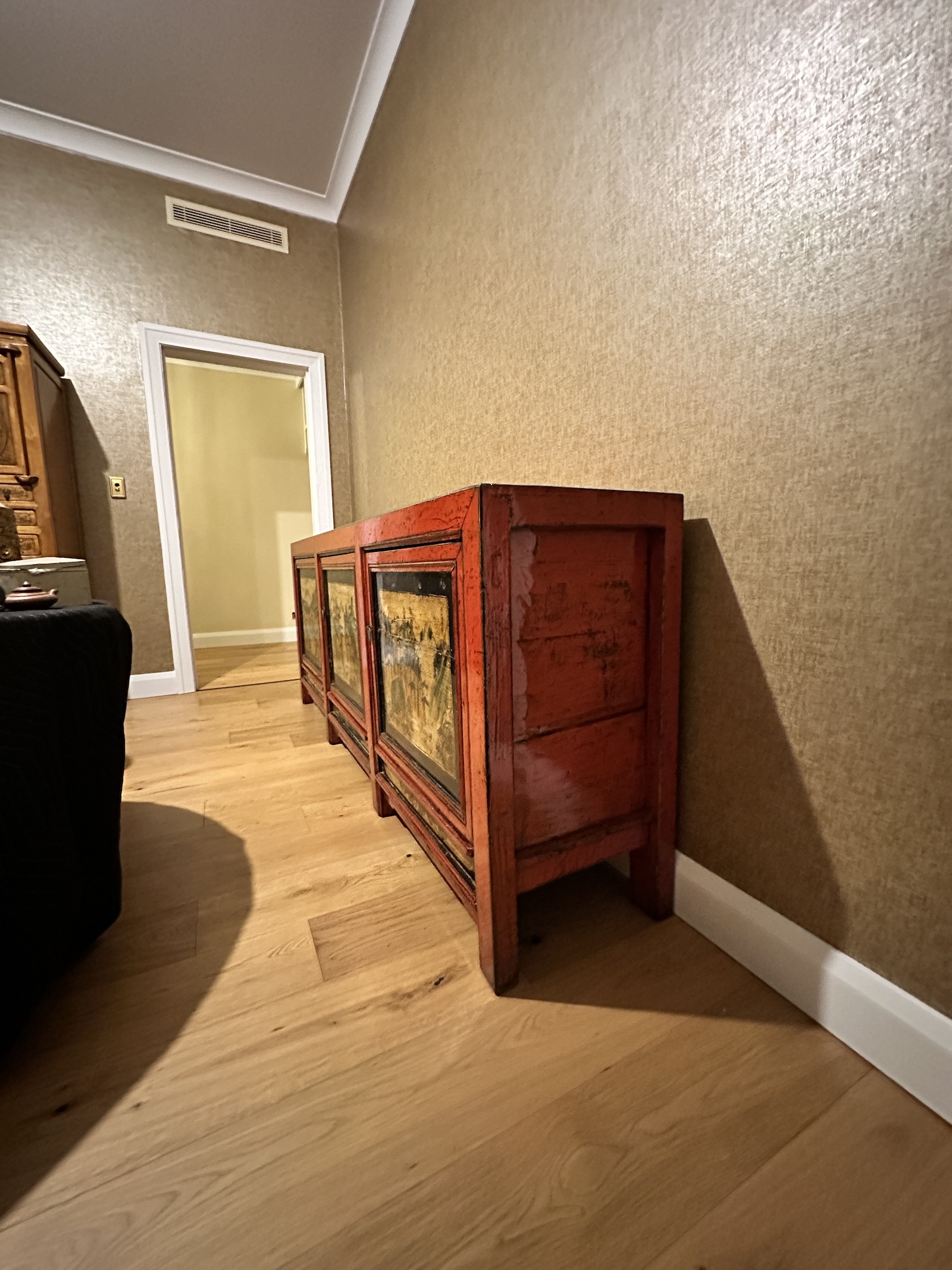 Side profile of antique red-lacquered elm sideboard showing cabinet joinery and protected access route during delivery to Manly
