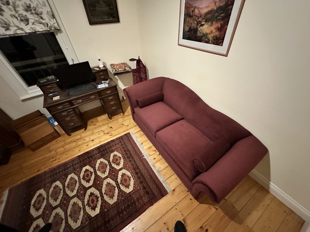 Meredith sofa bed beside timber cabinet after delivery (left side)