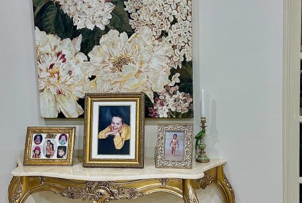 French classic gold console table with white marble top styled with artwork and frames in a Holgate NSW living space