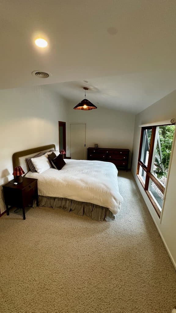 Main bedroom wide view with natural light showing the furniture placement.
