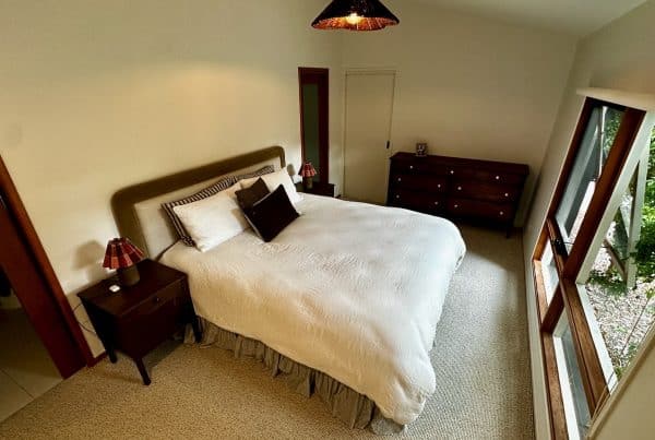 Wide view of the main bedroom in Barwon Heads with the Upcycled Wood Design dresser and bedside tables.