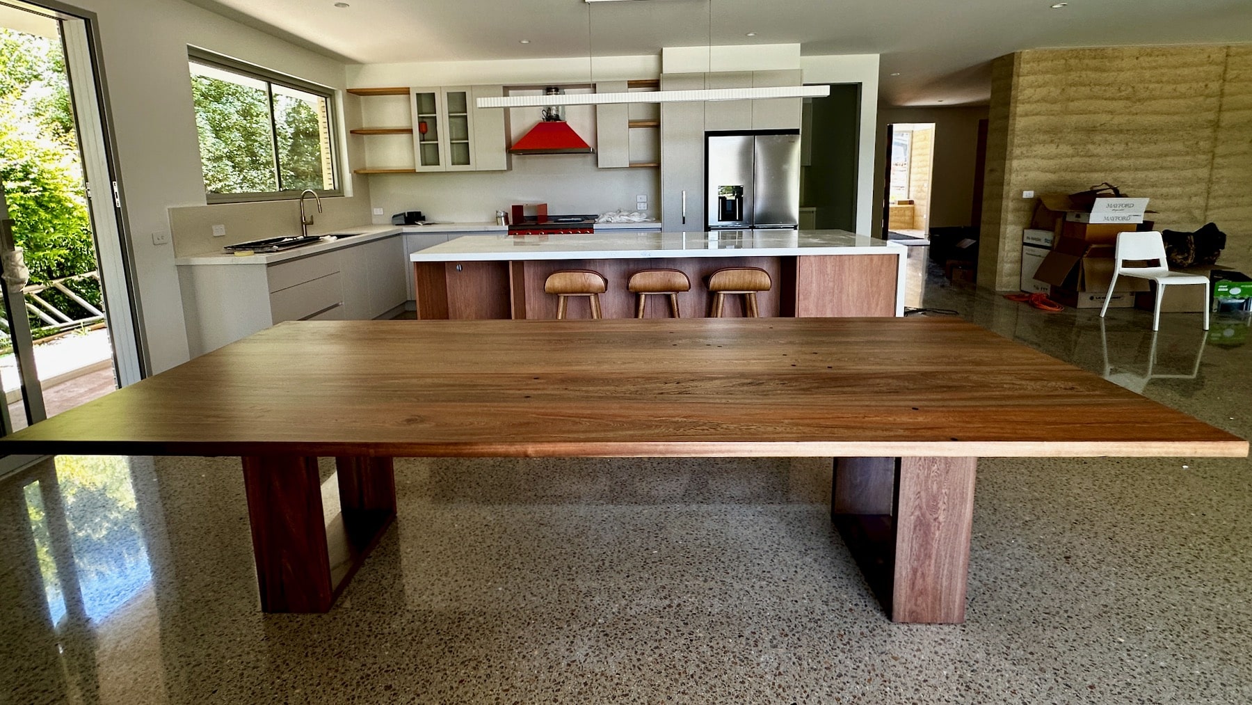 Wide kitchen view with the timber dining table installed and ready to use.