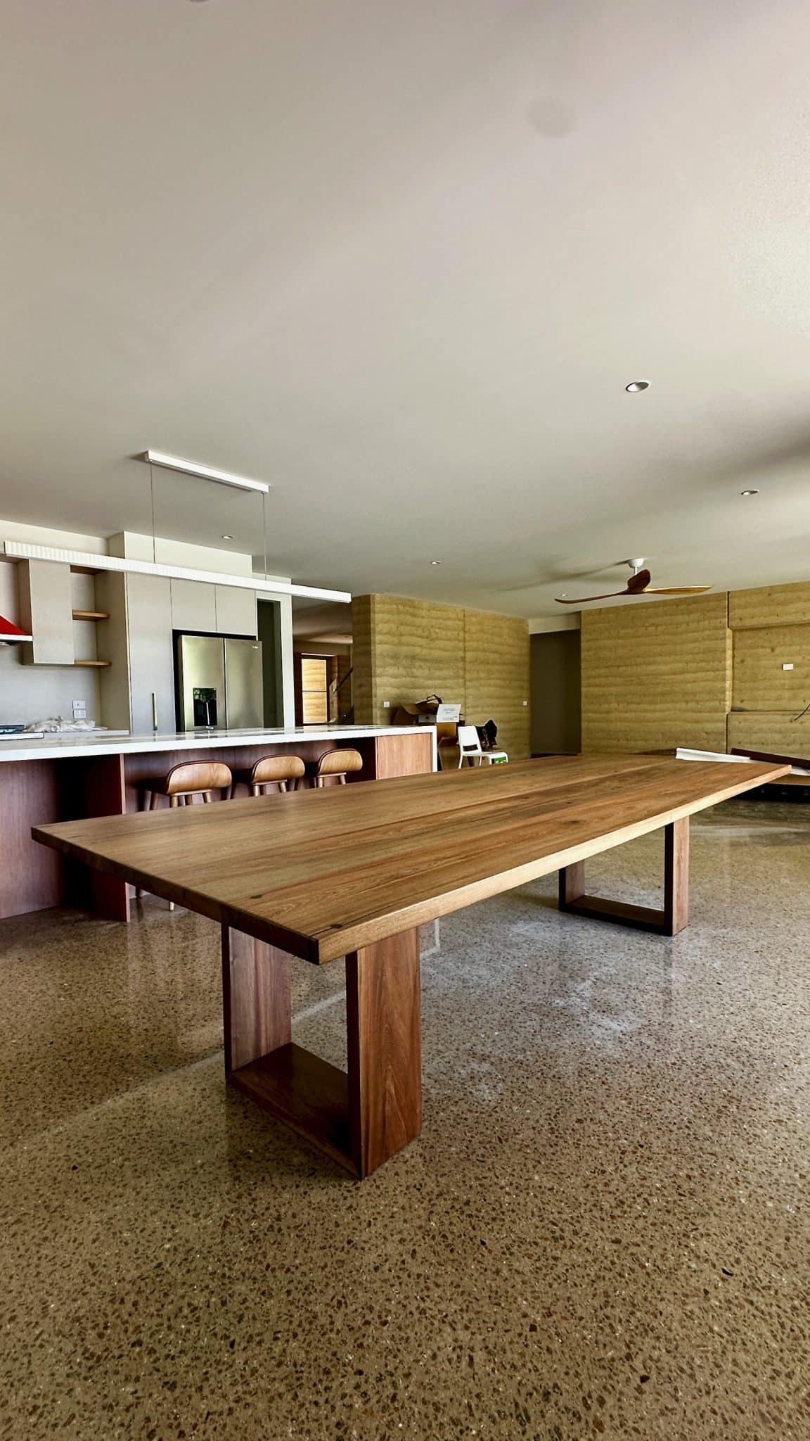 Angled room view of the timber dining table after delivery.