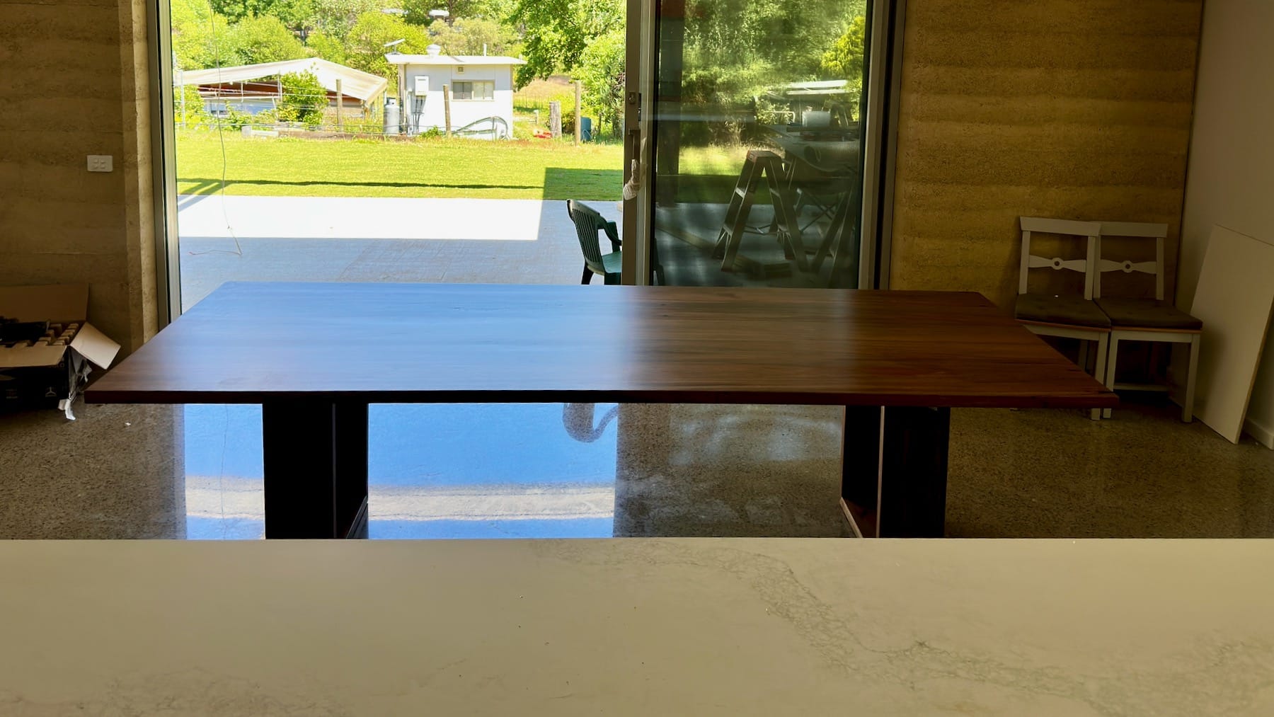 timber tabletop detail near the window showing finish and sheen.