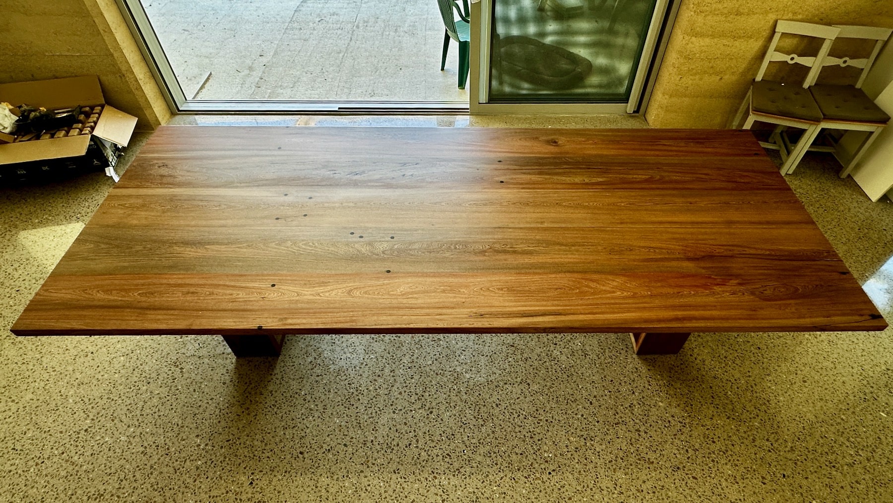 "Close-up of the timber tabletop surface showing natural colour variation.