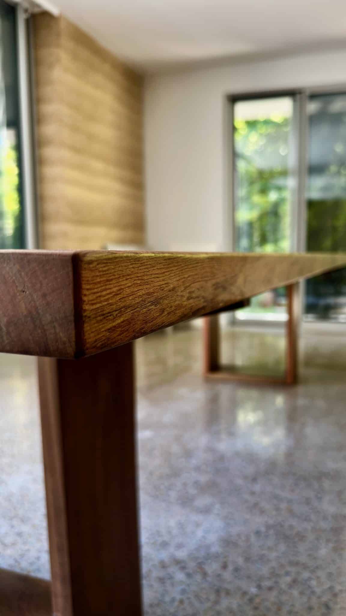 Close-up of the dining table corner showing timber thickness and edge.