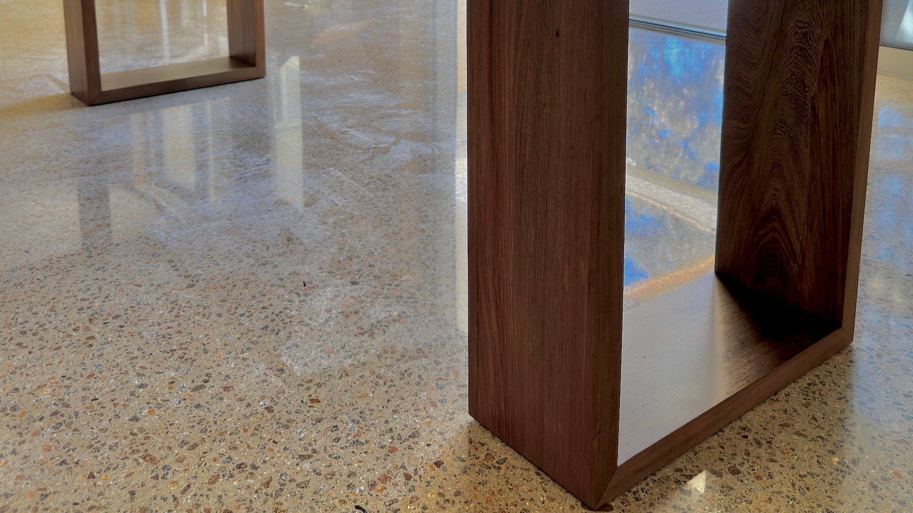Corner detail of the timber dining table showing joinery and finish.