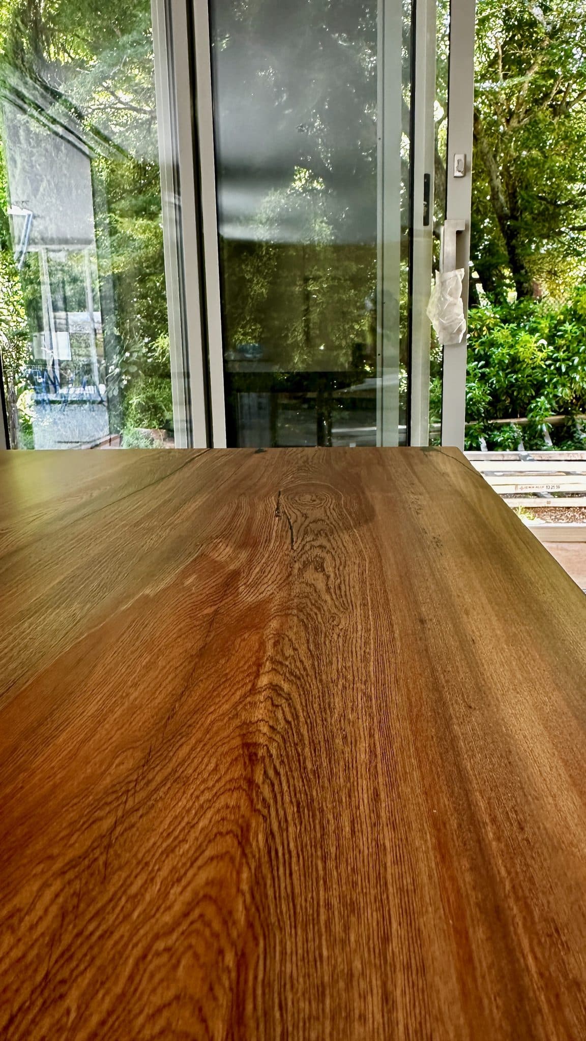 Close-up of the dining tabletop showing edge profile and grain.