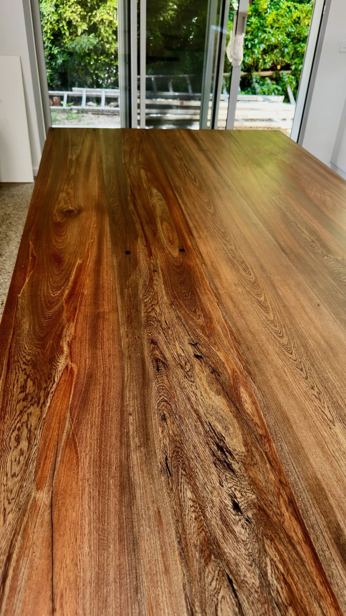 Close-up of the Christian Cole timber dining table top showing natural grain