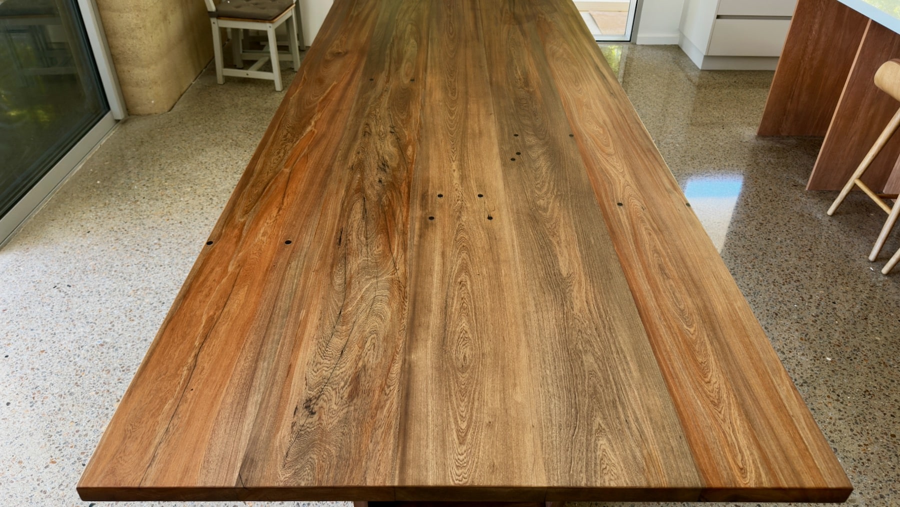 dining table top close-up showing grain pattern and colour tone.