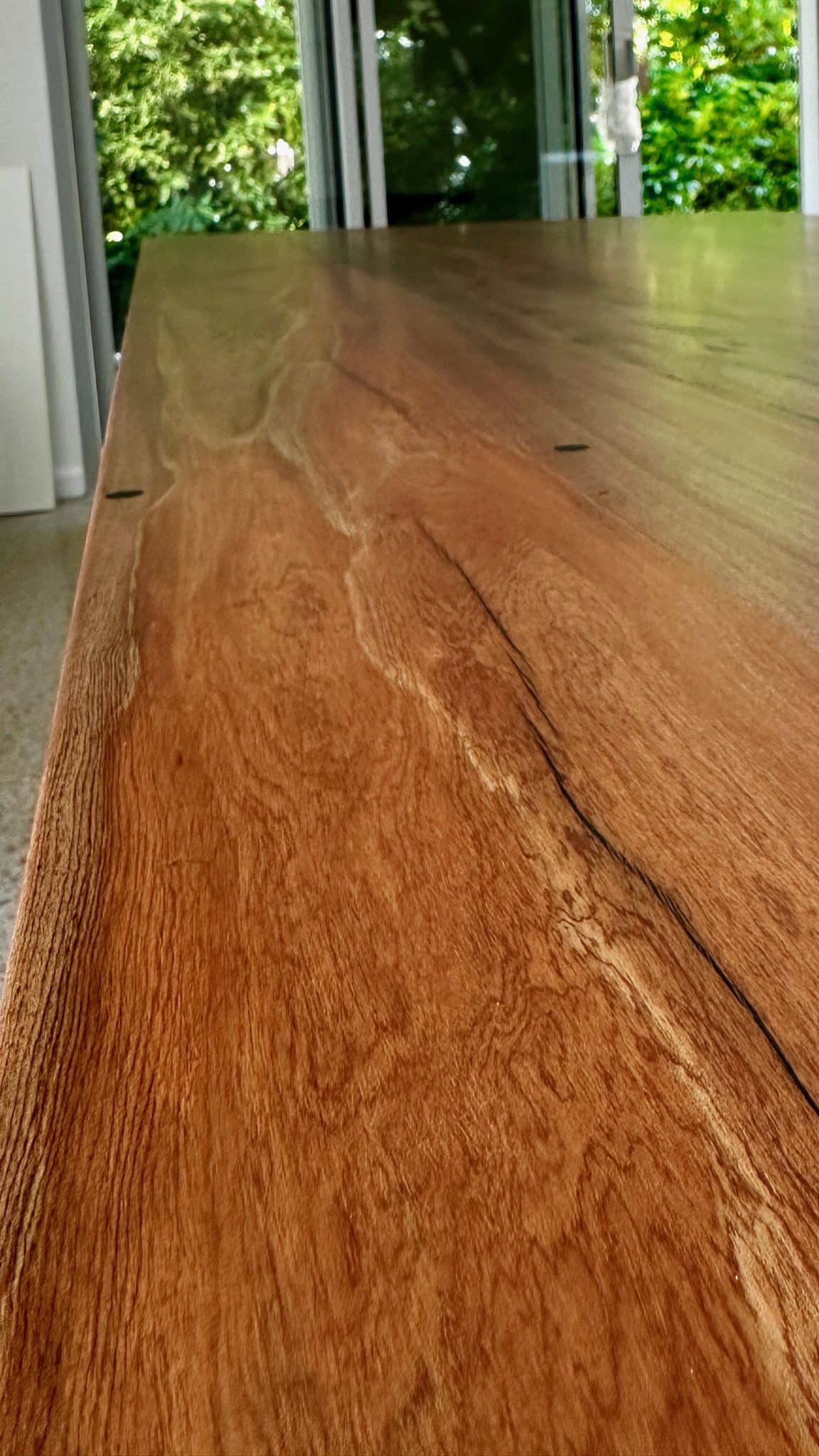 Close-up of the Christian Cole timber dining table grain with natural variation.