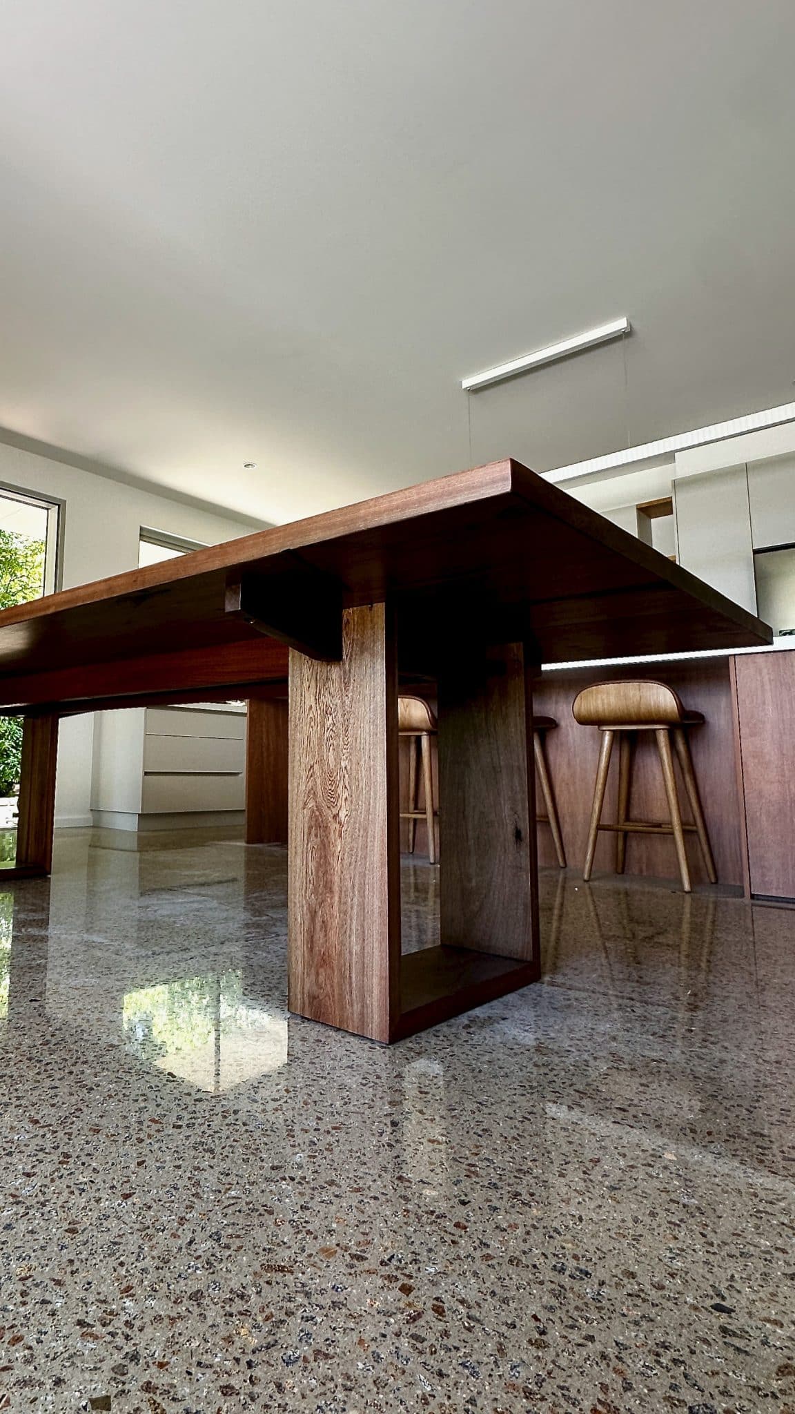 Low angle view of the dining table showing base design and clearance.