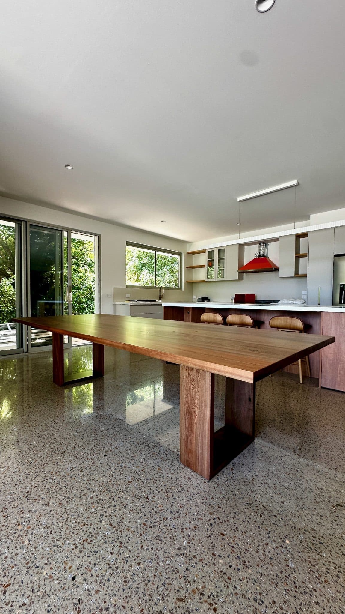 dining table placed in an open-plan kitchen and dining space.