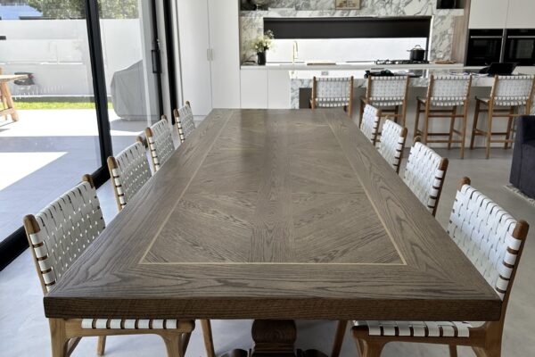 Long view along a Christian Cole dining table in a modern Melbourne home