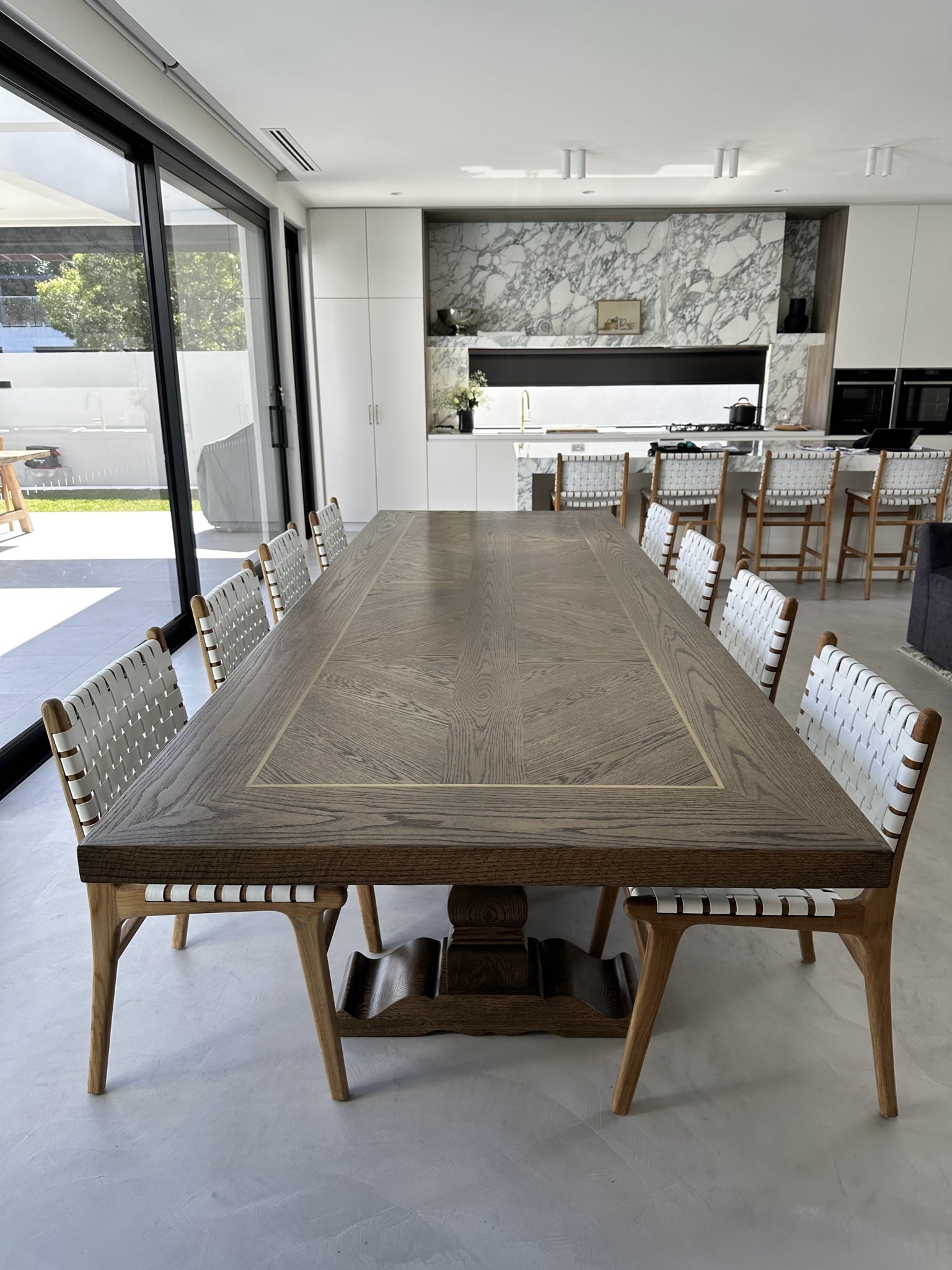 Long view along a Christian Cole dining table in a modern Melbourne home