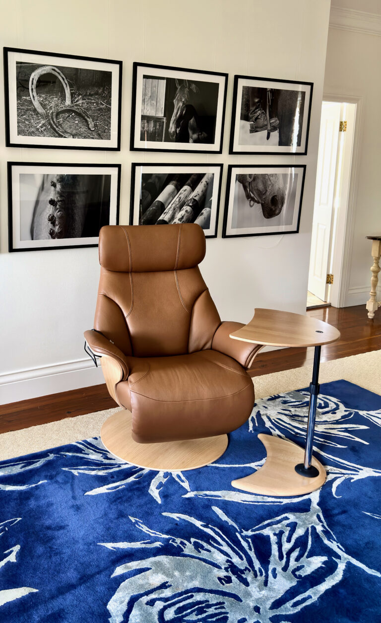 Clean centred view of a Strictly Comfort leather recliner in a finished room