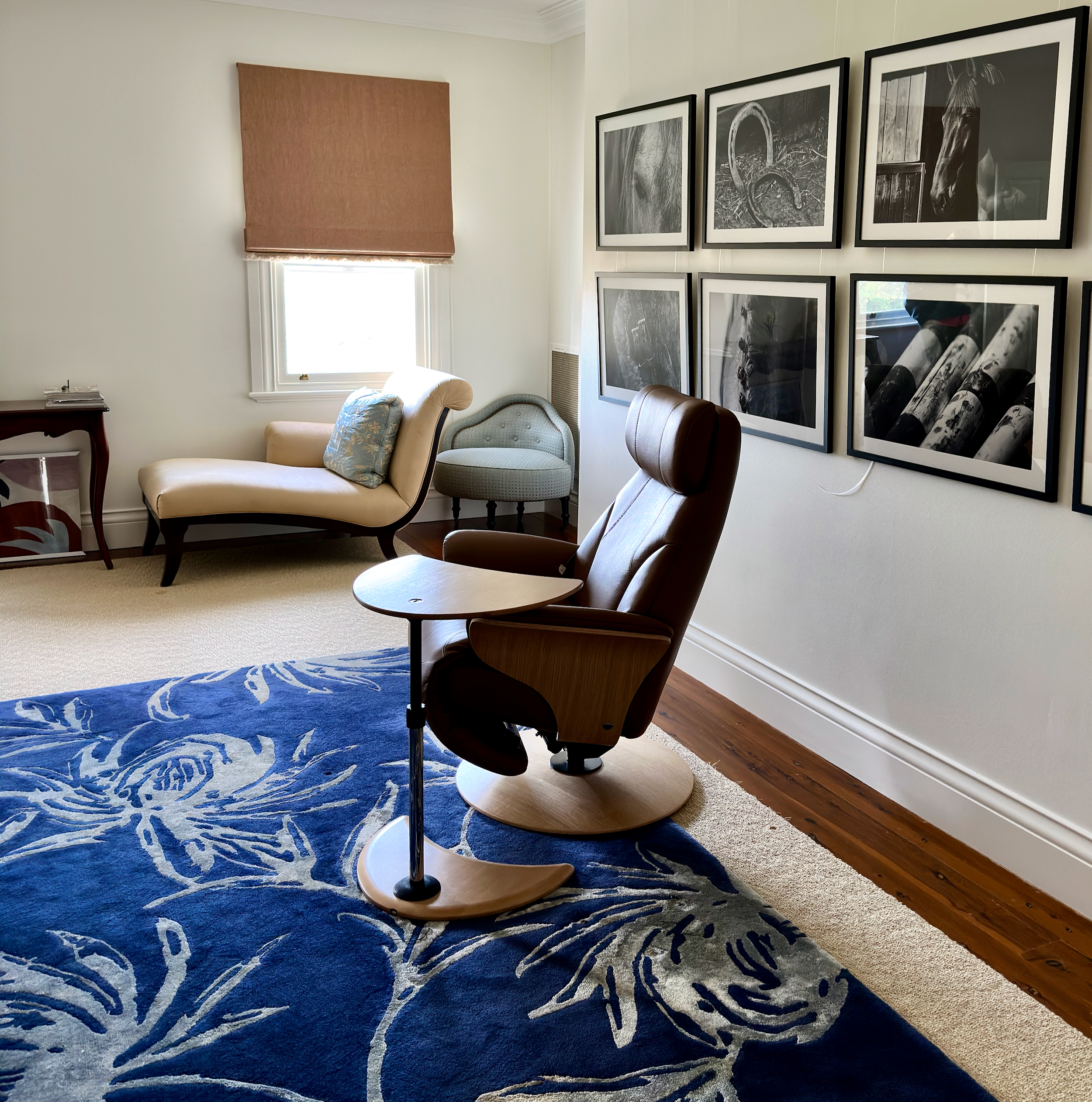 Side view of a Strictly Comfort recliner placed beside framed wall art