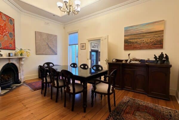 Dark timber dining table and eight chairs delivered and assembled in a McMahons Point home