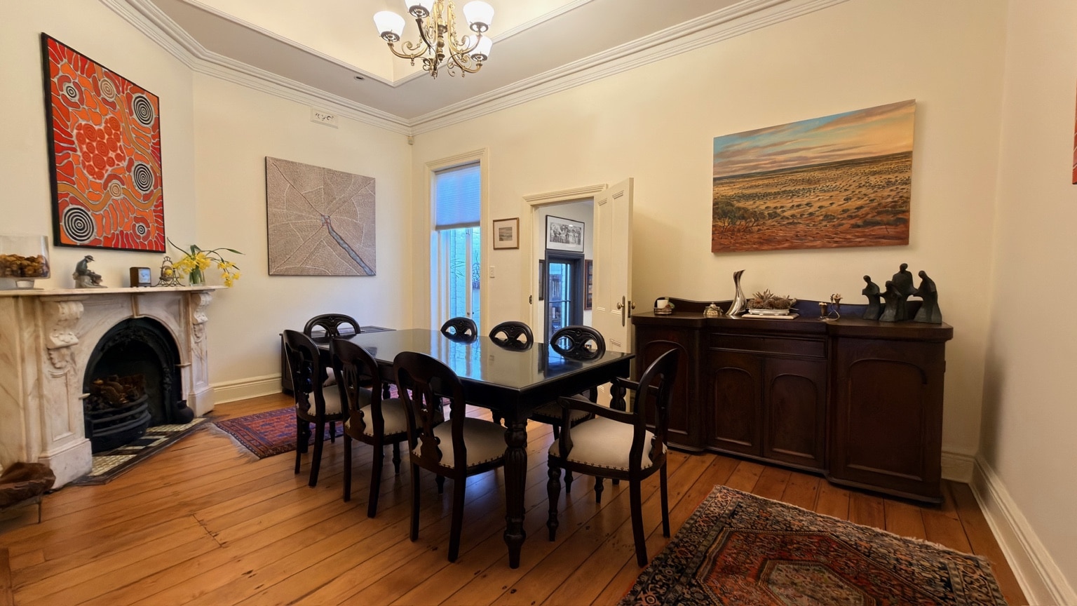 Dark timber dining table and eight chairs delivered and assembled in a McMahons Point home