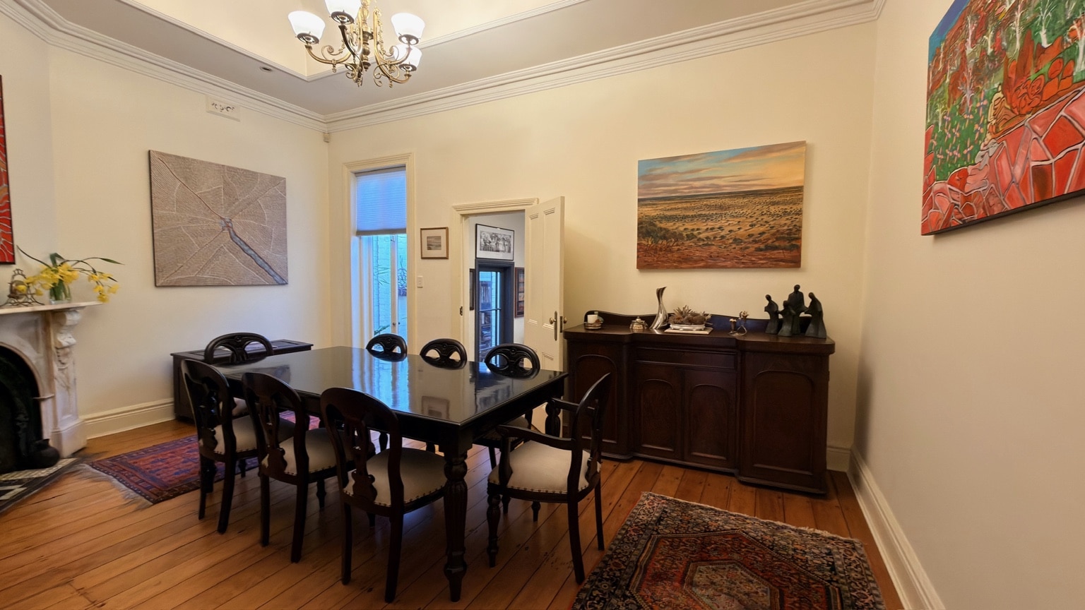 Completed dark timber dining suite positioned in a McMahons Point dining room