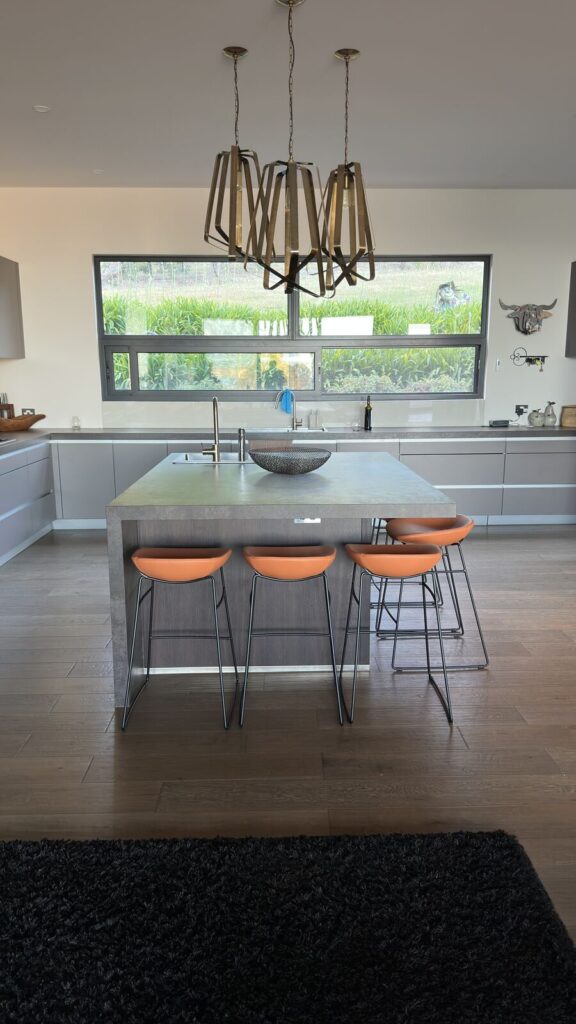 Tan bar stools contrasting with a grey kitchen interior