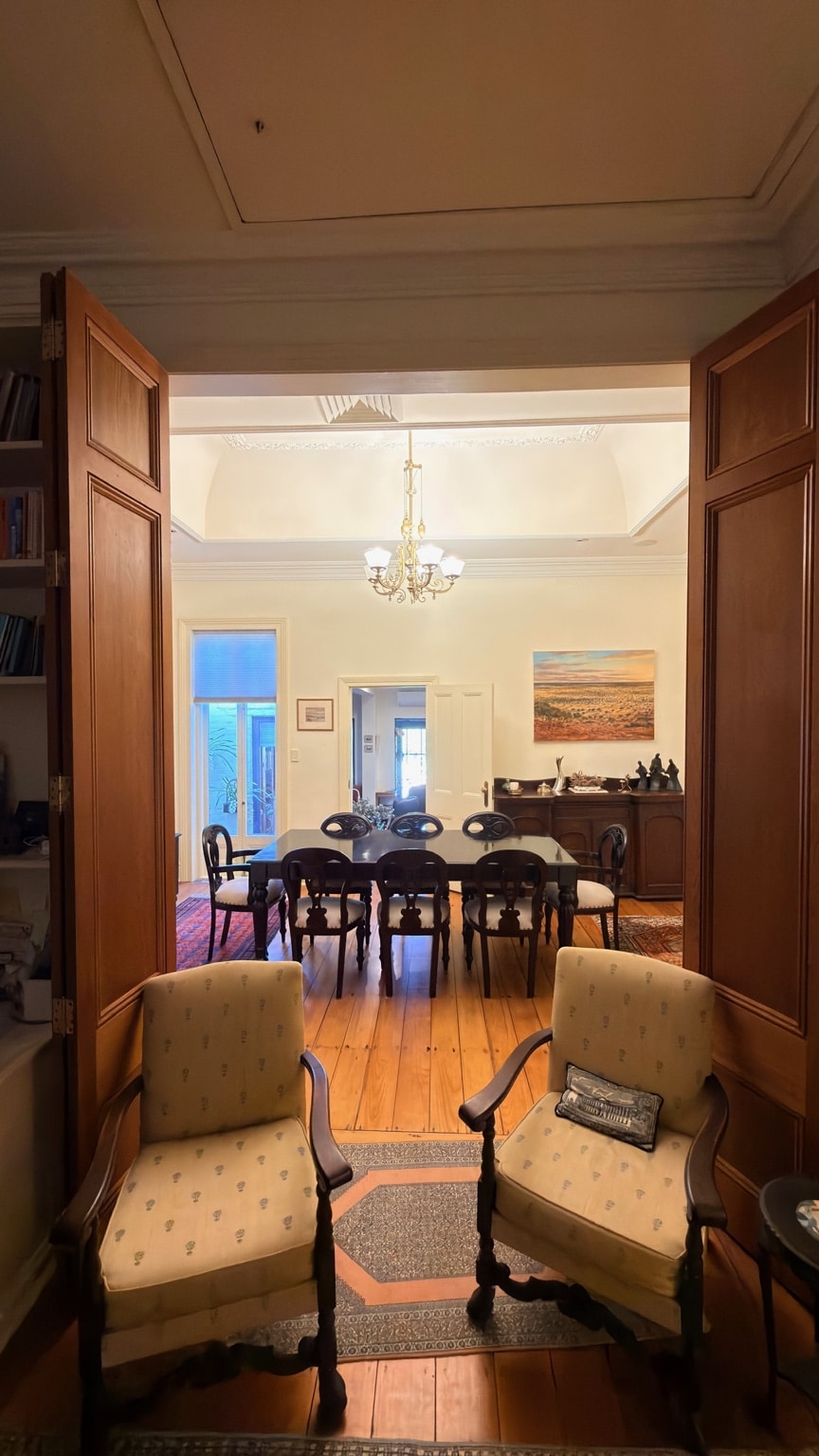 View through timber doors to the completed dining suite installation in McMahons Point
