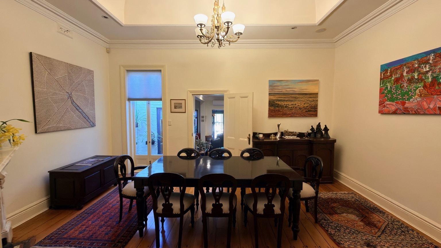 Wide view of a dark timber dining table and chairs after interstate furniture delivery