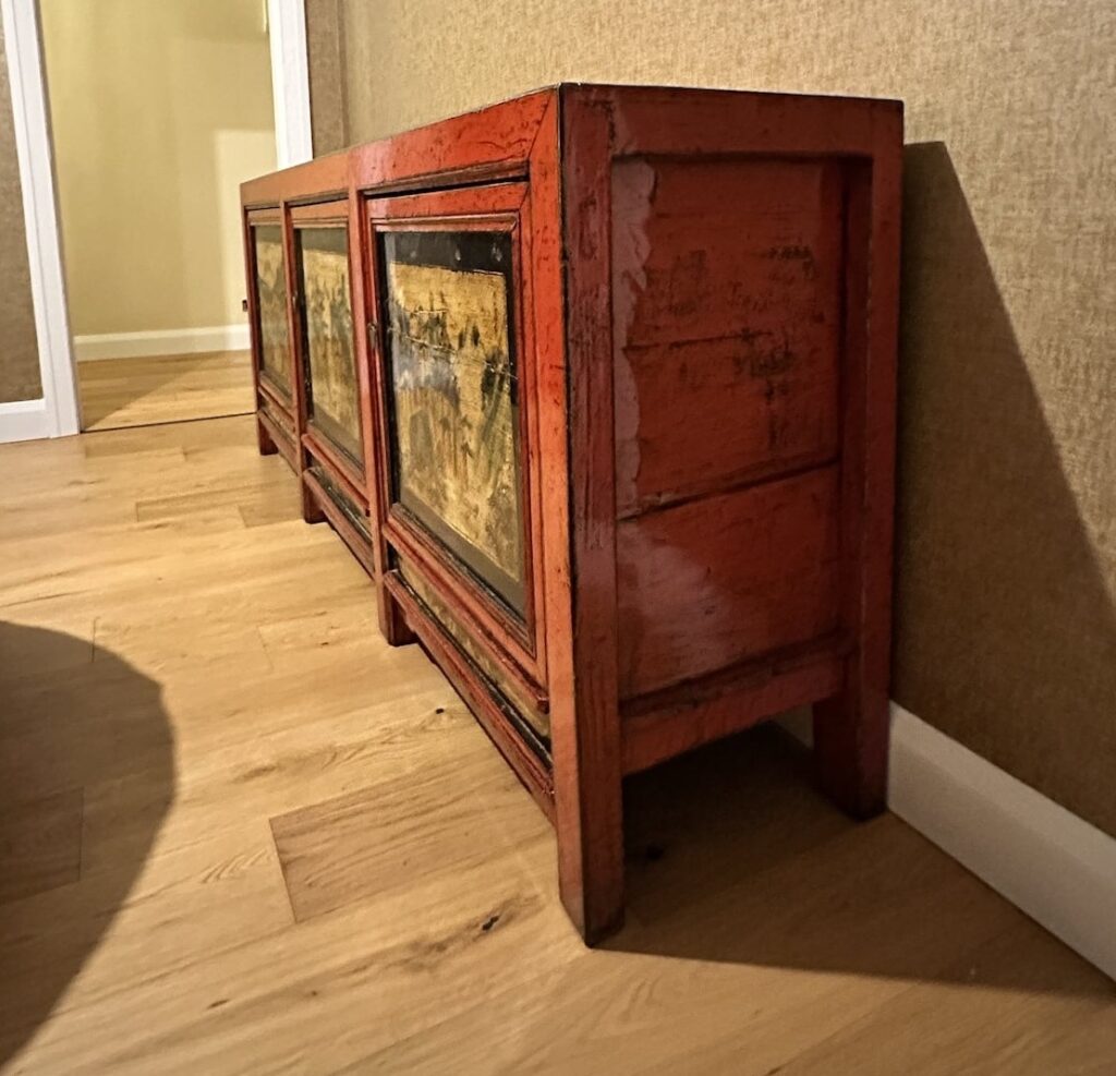 Side view showing the depth, painted panels and feet of the antique red elm sideboard in Manly